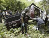 Policemen and soldiers inspect a security truck which was hit by a roadside bomb in southern Thailand's Yala province on September 16, 2008. Militants shot dead two Muslim rubber tappers in Thailand's rebellious south on Tuesday, then detonated a bomb wounding five policemen and three villagers in a patrol security truck rushing to the scene, police said. From Reuters Pictures by REUTERS.