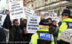Muslim extremists brandishing banners calling British soldiers 'Butchers' 